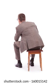 Back View Of A Young Business Man Sitting On A Chair. On A White Background