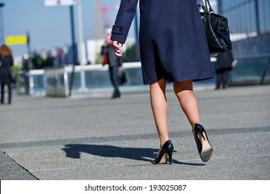 Back View Of Young Business Woman Walking On The City Street