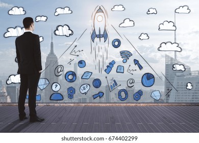Back view of young businessman standing on wooden deck and looking at abstract business sketch on city background. Leadership concept. Double exposure  - Powered by Shutterstock
