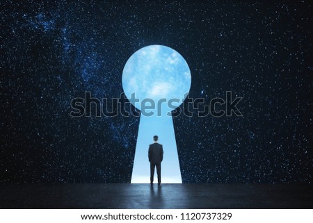 Back view of young businessman standing against keyhole door on starry sky background. Dream, success, opportunity and access concept