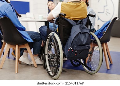 Back view at young college student in wheelchair participating in group discussion, copy space