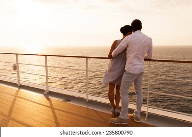 back view of young couple hugging at sunset on cruise ship - Powered by Shutterstock