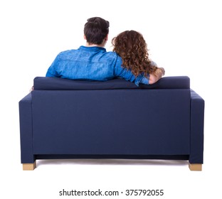 Back View Of Young Couple Sitting On Sofa Isolated On White Background