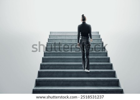 Back view of young female climbing stairs. Success, future and career growth concept