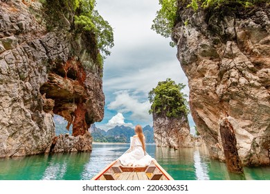 Back View of Young Female Tourist in Dress and Hat at Longtail Boat near Famous Three rocks with Limestone Cliffs at Cheow Lan Lake. Travel Woman Sitting on Boat in Khao Sok National Park in Thailand - Shutterstock ID 2206306351