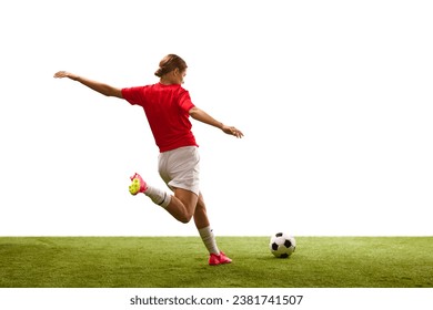 Back view. Young girl, football player in motion, playing on green grass, ready to hit ball isolated on white background. Concept of sport, competition, action, success, motivation. Copy space for ad - Powered by Shutterstock