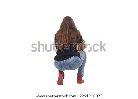 back  view of a young girl long-haired sitting squatting on white background