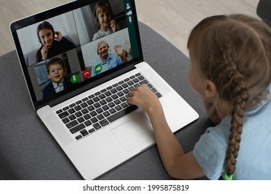 Back view of young girl sit at home, talk have online video call lesson with teacher or tutor, teenage schoolgirl engaged in webcam conversation, study distant use web conference app on laptop - Shutterstock ID 1995875819