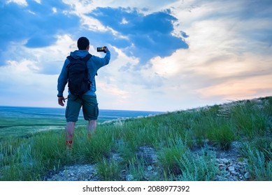 Back View Young Male Hiker Looks At Horizon