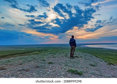 Back View Young Male Hiker Looks At Sea And Horizon