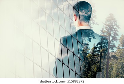 Back view of young man on modern building and green landscape background. Research concept. Double exposure - Powered by Shutterstock