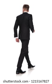 Back View Of A Young Man In Tuxedo Walking On White Background