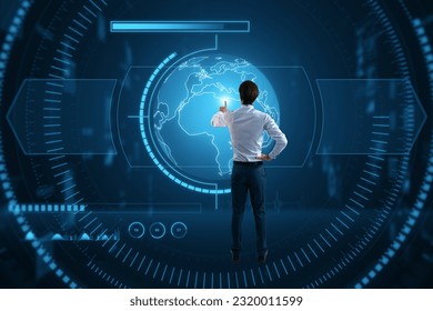 Back view of young man using creative glowing blue map or globe hologram on blurry background. Earth, metaverse and technology concept