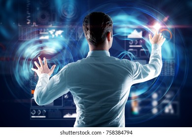 Back view of young man using abstract digital business interface. Infograph and analytics concept. Double exposure