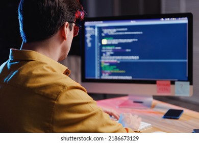 Back View Young Student Software Male Engineer IT Specialist Man In Shirt Work At Home Writing Code On Desktop Pc Computer, Typing Language Script. Program Development Concept. Focus On Programmer.