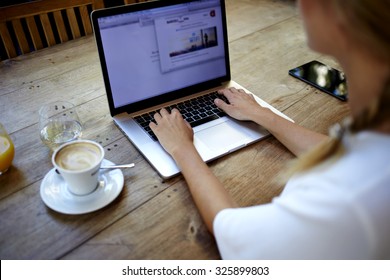  Back View Of Young Successful Female Freelancer Use Net-book For Distance Work During Her Recreation Time, Woman's Hands Keyboarding On Portable Laptop Computer With Blank Copy Space On The Screen