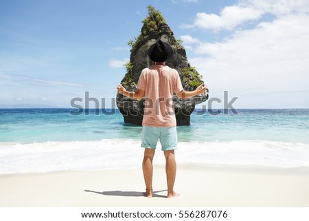 Similar – Man standing barefoot on a wooden walkway