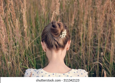 Back View Of Young Woman With Hair Bun
