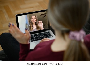 back view of young woman have webcam online meeting with female, talk on video call on laptop with woman , virtual digital conference on computer. High quality photo - Shutterstock ID 1934034956