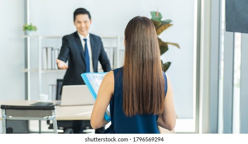 Back View Of Young Woman Person Who Apply For A Job With Resume To Sit Down For Interview.