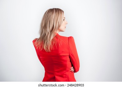 Back View Of Young Woman In Red Jacket