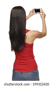 Back View Of Young Woman Taking Pictures Through Cell Phone, Over White Background