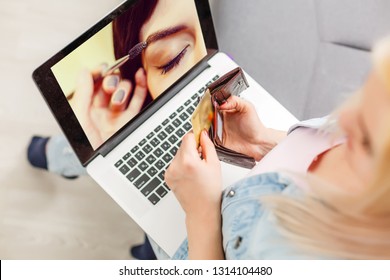 Back View Of Young Woman Watching On Laptop Video Blog How To Apply Make Up