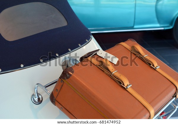 Back of vintage car with\
luggage 
