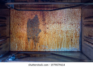 The Back Wall Of The Gas Oven Splattered With Grease And Smoke, The Front And Background Are Blurred