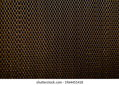 The back wall of the refrigerator with a radiator grill close-up.