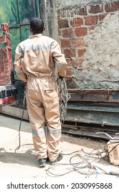 Back Welder Working In The Workshop