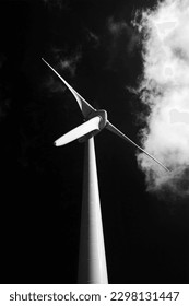 Back and white minimalist composition with wind turbine, cloud and dark sky