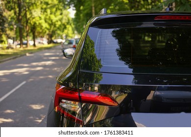 Back window of black car parked on the street in summer sunny day, rear view. Mock-up for sticker or decals - Shutterstock ID 1761383411