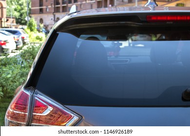 Back window of a car parked on the street in summer sunny day, rear view. Mock-up for sticker or decals - Shutterstock ID 1146926189