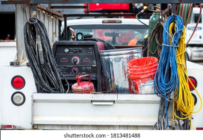 Back Of Work Pickup Truck Loaded With Construction Equipment, Generator, Bucket, Gas Can, Hoses, Trash Can, Tailgate, Ladder, Welding Tank, 