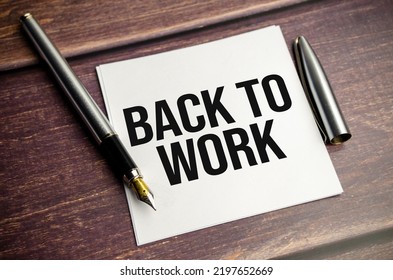 Back To Work Words On Paper With Pen And Wooden Background