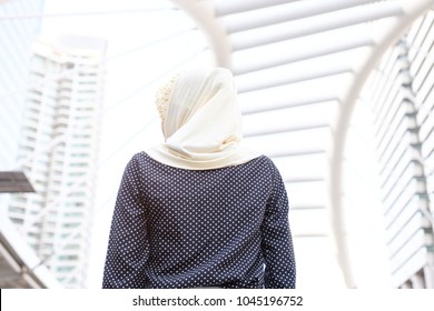 In back of young muslim woman looking at building city,Portrait of Muslim people concept