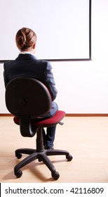 Back Of A Young Woman In An Office Chair