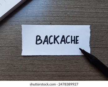 Backache writting on table background.