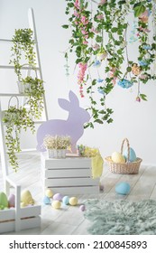 Backdrop For Photo Studio With Easter Decorations For Kids And Family Photo Sessions. Plants, Flowers, Wooden Rabbit, Colorful Dyed Eggs, Baskets. 