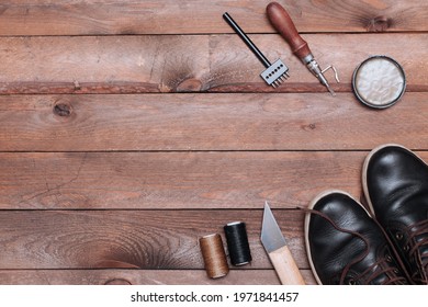 Backdrop of Shoes maker tools on wooden table. Set of Leather crafting tools - Powered by Shutterstock