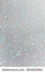 A backdrop shows a mix of small dots in various colors shining under light. The texture creates an interesting visual effect. This setting can be used for creative projects.