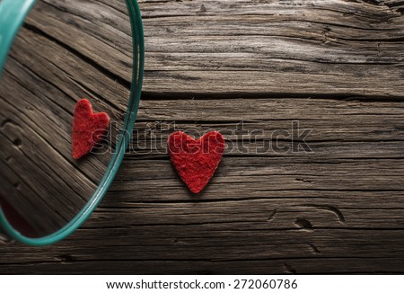 Backdrop of two red hearts lie on old retro vintage aged grunge style background . Valentine's day. Reflection in circle mirror Couple of sign love Idea symbol concept reciprocity, mutually
