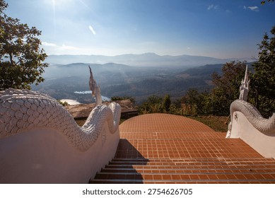 The backdrop of Wat Doi Mon That Sirithammaram in Lampang province, Thailand, high in the mountains, offers stunning mountain views and unseen misty landscapes of Thailand. It is an ancient temple that consistently attracts tourists from around the world.