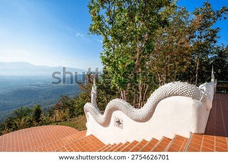 The backdrop of Wat Doi Mon That Sirithammaram in Lampang province, Thailand, high in the mountains, offers stunning mountain views and unseen misty landscapes of Thailand. It is an ancient temple that consistently attracts tourists from around the world.