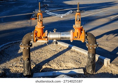 Backflow prevention device, which is an assembly of valves and pipes designed to ensure water flows in a single direction and prevent contamination of potable water supplies