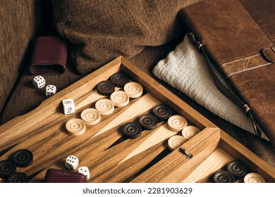 Backgammon game with dices on wooden board.