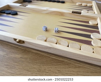 Backgammon game. Wooden board with backgammon game pieces with dice - Powered by Shutterstock