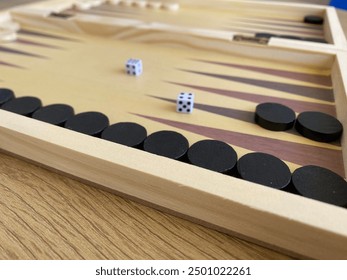 Backgammon game. Wooden board with backgammon game pieces with dice - Powered by Shutterstock