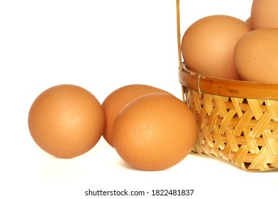 Many​ chicken​ egg​s​ with​ bamboo​ wicker​ basket​ isolated​ on​ white​ background.